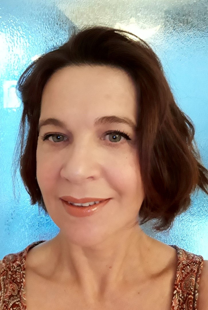 A headshot of Denise